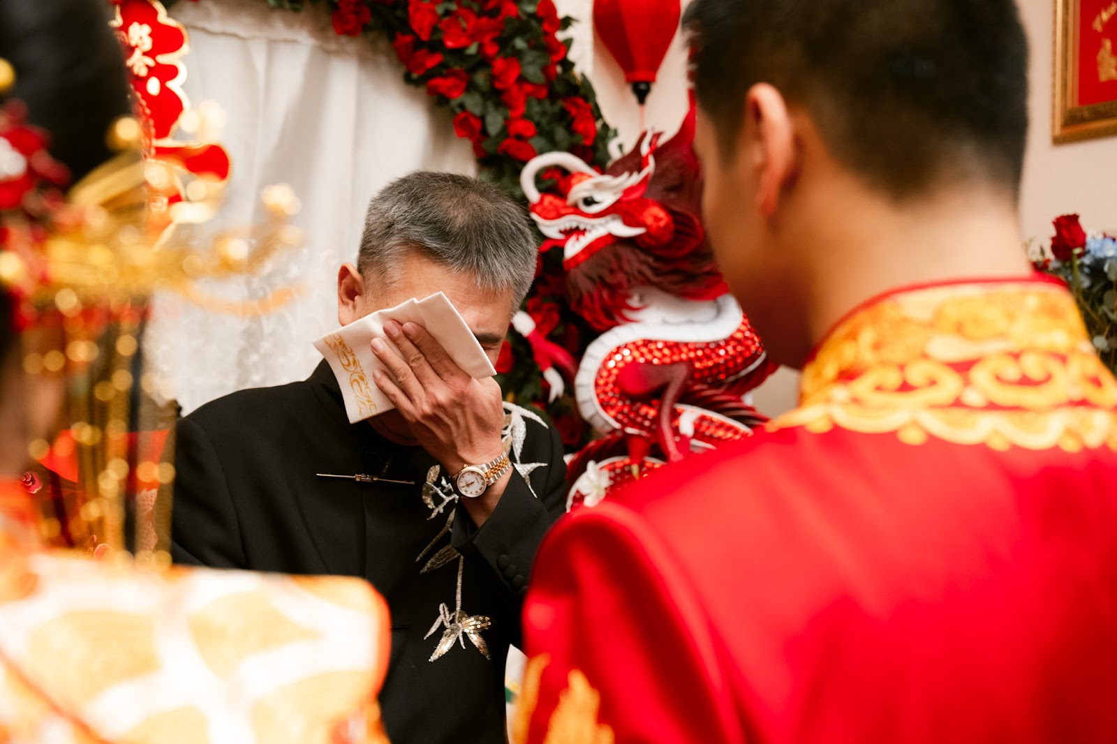 A quiet moment during the traditional tea ceremony, the couple dressed in red