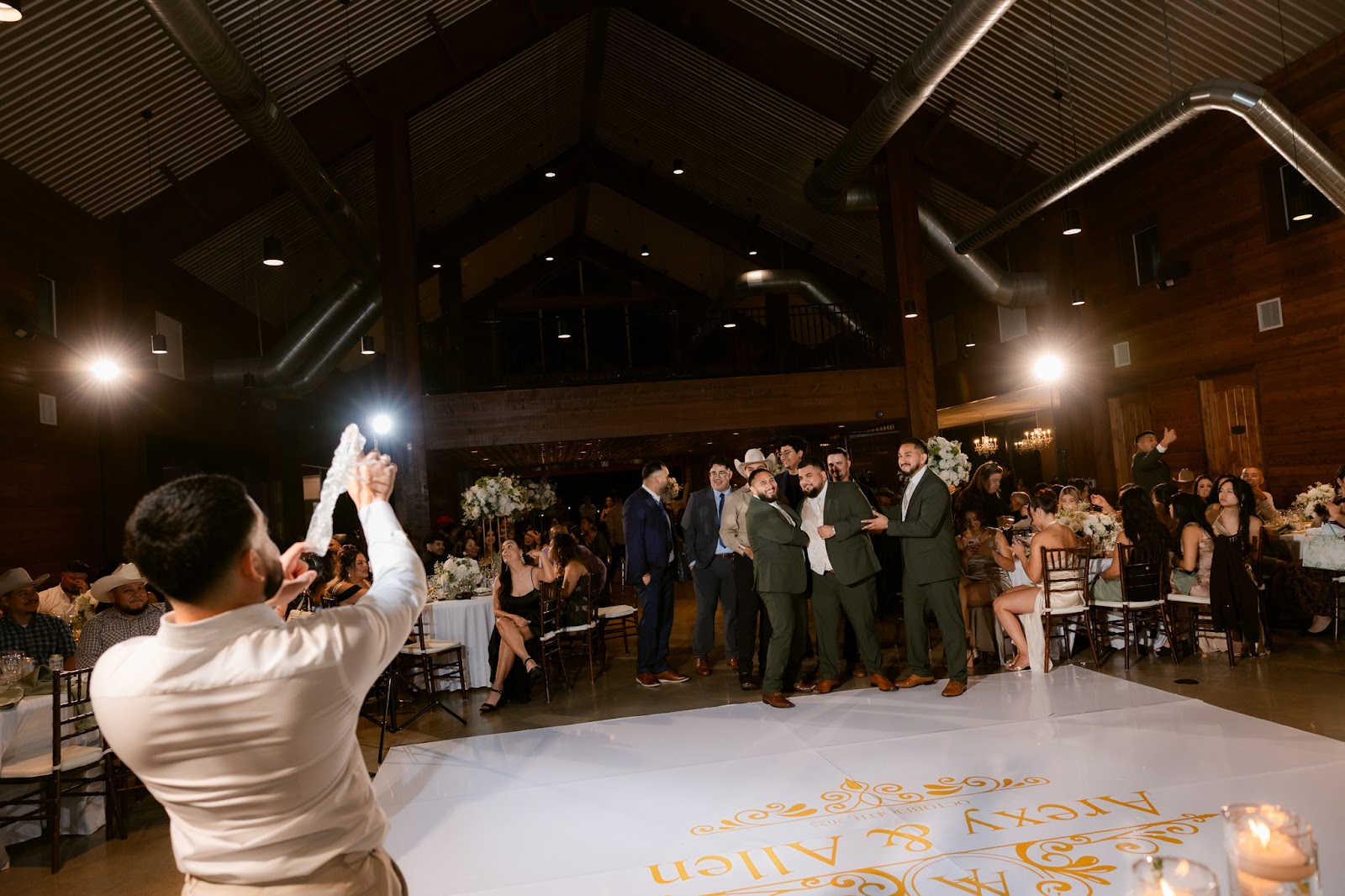 A first dance wrapped in drifting smoke, lit by a single overhead beam