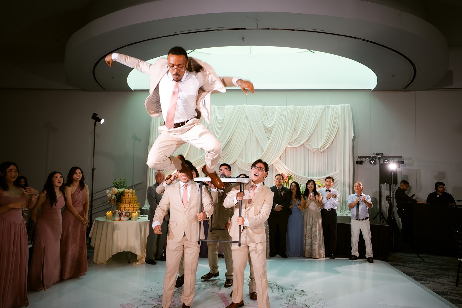 A joyful guest mid-air during the reception dancing