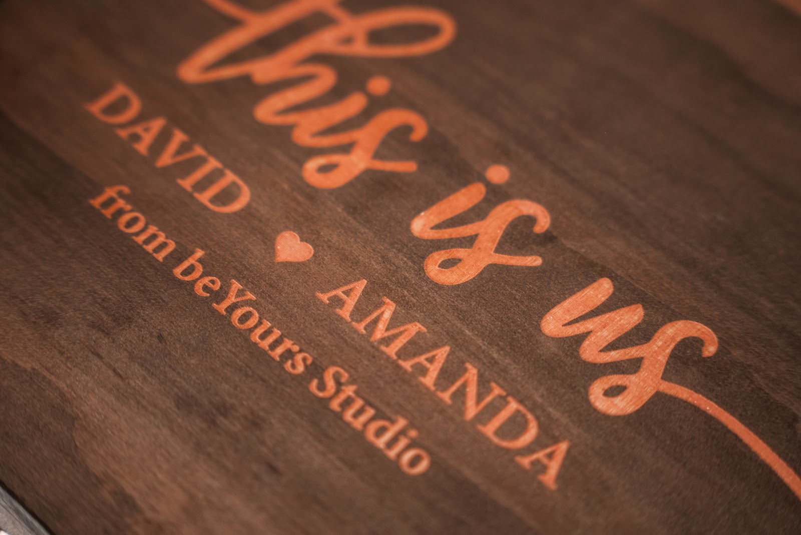 A handcrafted wooden keepsake box engraved with a couple's names